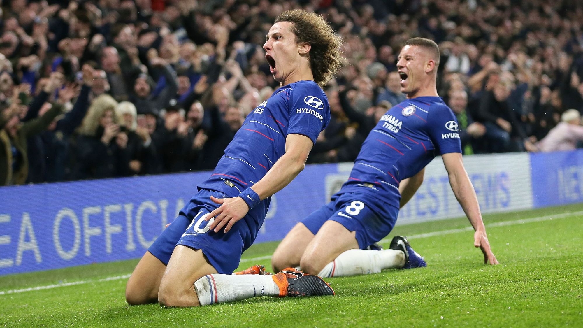 Chelsea’s David Luiz, left, celebrates after scoring his side’s opening goal during the English Premier League soccer match between Chelsea and Manchester City.
