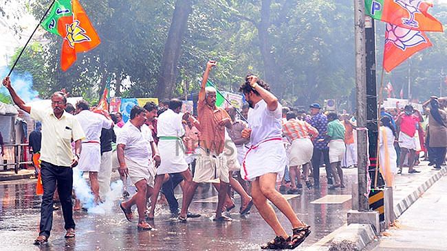 (Photo Courtesy: The News Minute/<a href="https://www.thenewsminute.com/article/bjp-yuva-morcha-protest-turns-violent-hartal-thiruvananthapuram-tuesday-93107">Sreekesh Raveendran Nair</a>)