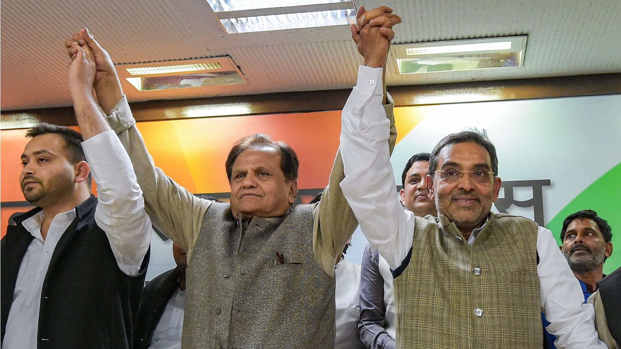 RLSP leader Upendra Kushwaha raises hands with Congress leader Ahmed Patel and RJD’s Tejashwi Yadav after joining the grand alliance.&nbsp;