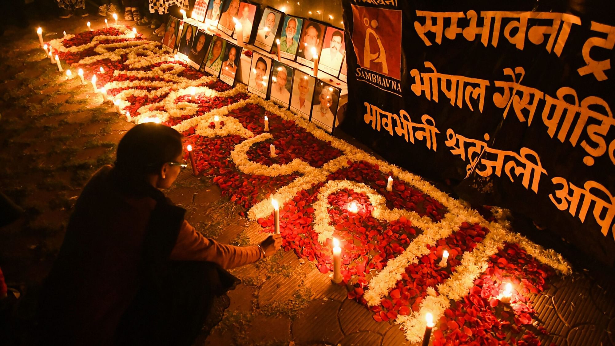 Survivors of the 1984 Bhopal Gas Disaster light candles to pay tribute to the victims, on the 34th anniversary of the tragedy, in Bhopal.
