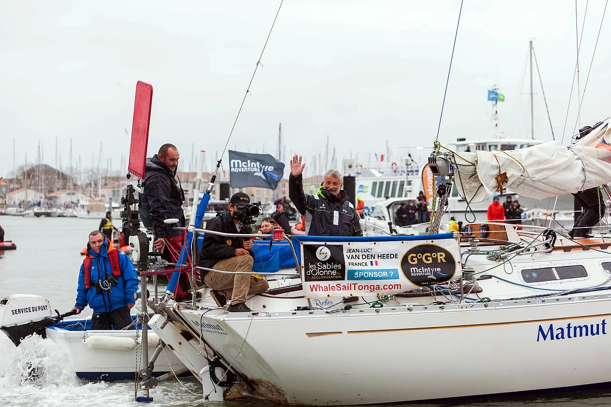 French sailor Jean-Luc Van Den Heede, 73, waves aboard his Rustler 36, Matmut, after winning the Golden Globe Race, a single-handed round the world yacht race, after 212 days alone at sea, in Les Sables-d’Olonne harbor, western France, Tuesday, Jan. 29, 2019.