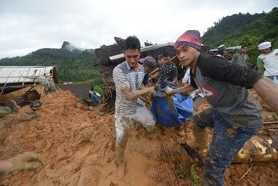 SUKABUMI, Jan. 1, 2019 (Xinhua) -- Rescuers evacuate a body at a house after landslides struck at Sinaresmi village in Suka Bumi district, West Java, Indonesia, Jan. 1, 2019. A total of 41 villagers were missing after fatal landslides struck Suka Bumi district in Indonesia