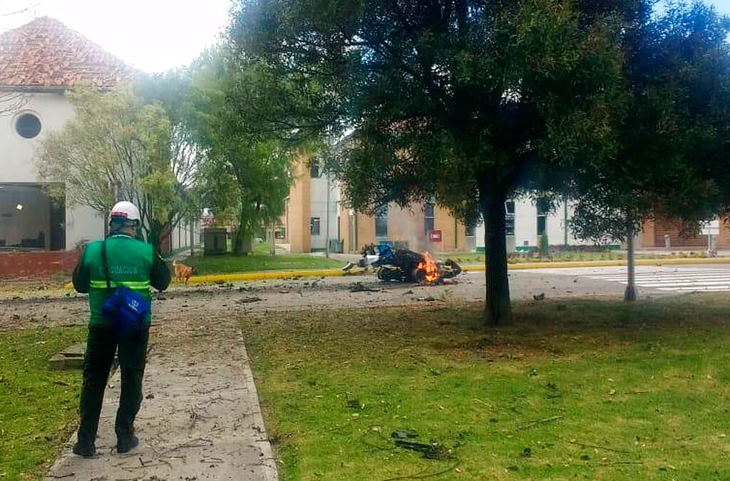 Flames rise from a deadly car bombing at a police academy in Bogota, Colombia, on 17 January.