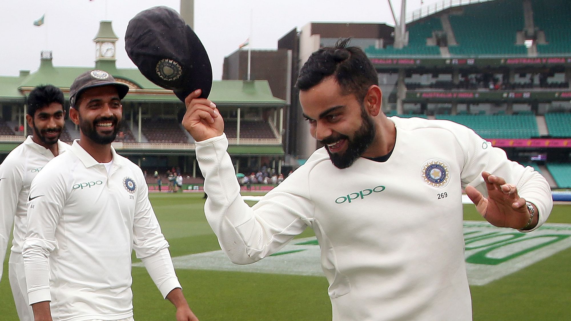Indian captain Virat Kohli tips his hat as he celebrates with teammates after their historic Test series win in Australia.