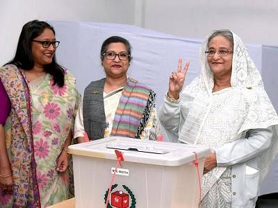 DHAKA, Dec. 30, 2018 (Xinhua) -- Bangladesh Prime Minister Sheikh Hasina(R) flashes a victory sign after casting her vote at a polling station in Dhaka, capital of Bangladesh, on Dec. 30, 2018. Nationwide voting opened Sunday morning in Bangladesh
