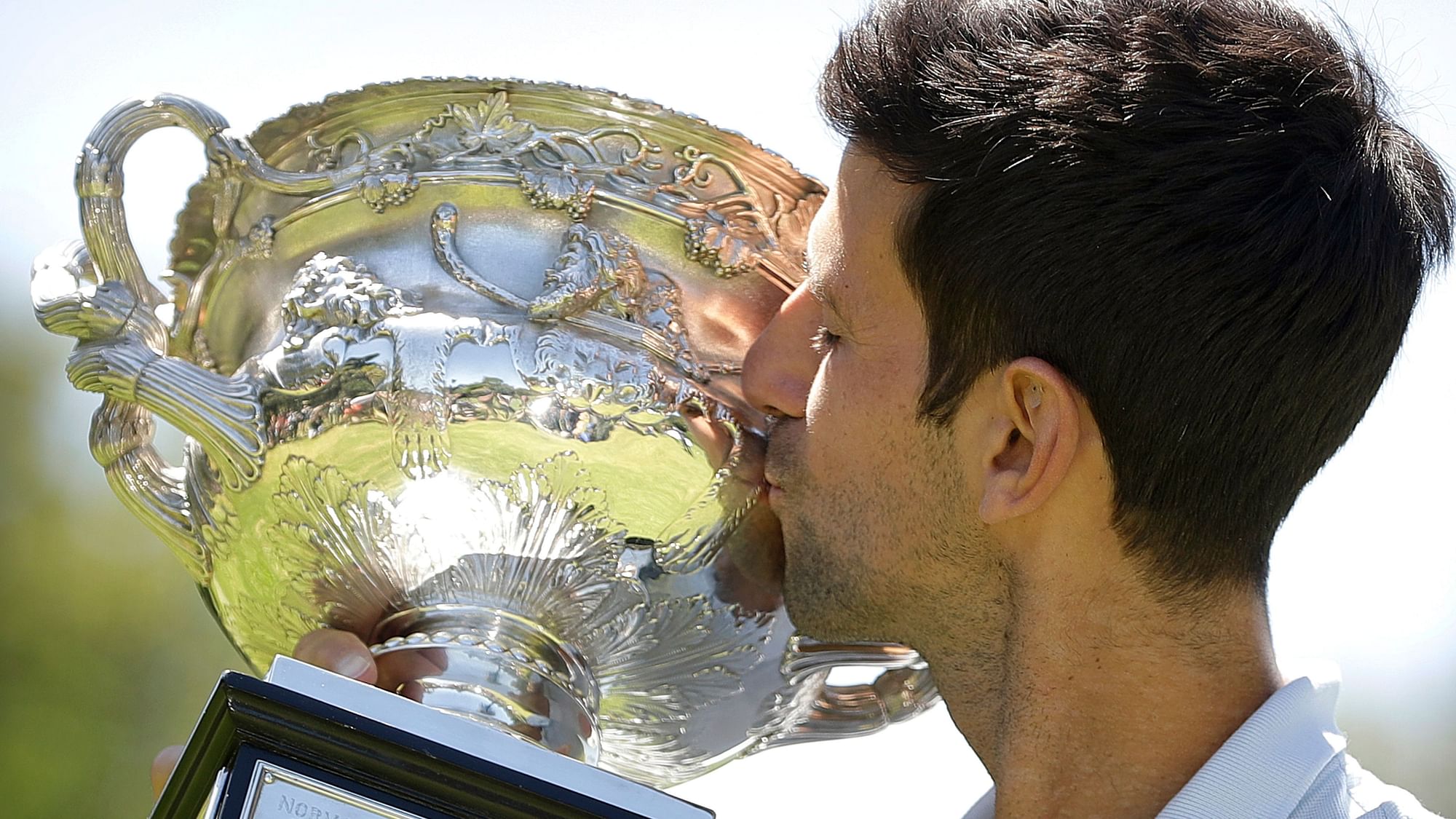 Novak Djokovic poses with the trophy at Melbourne’s Royal Botanic Gardens a day after capturing a record seventh Australian Open crown.
