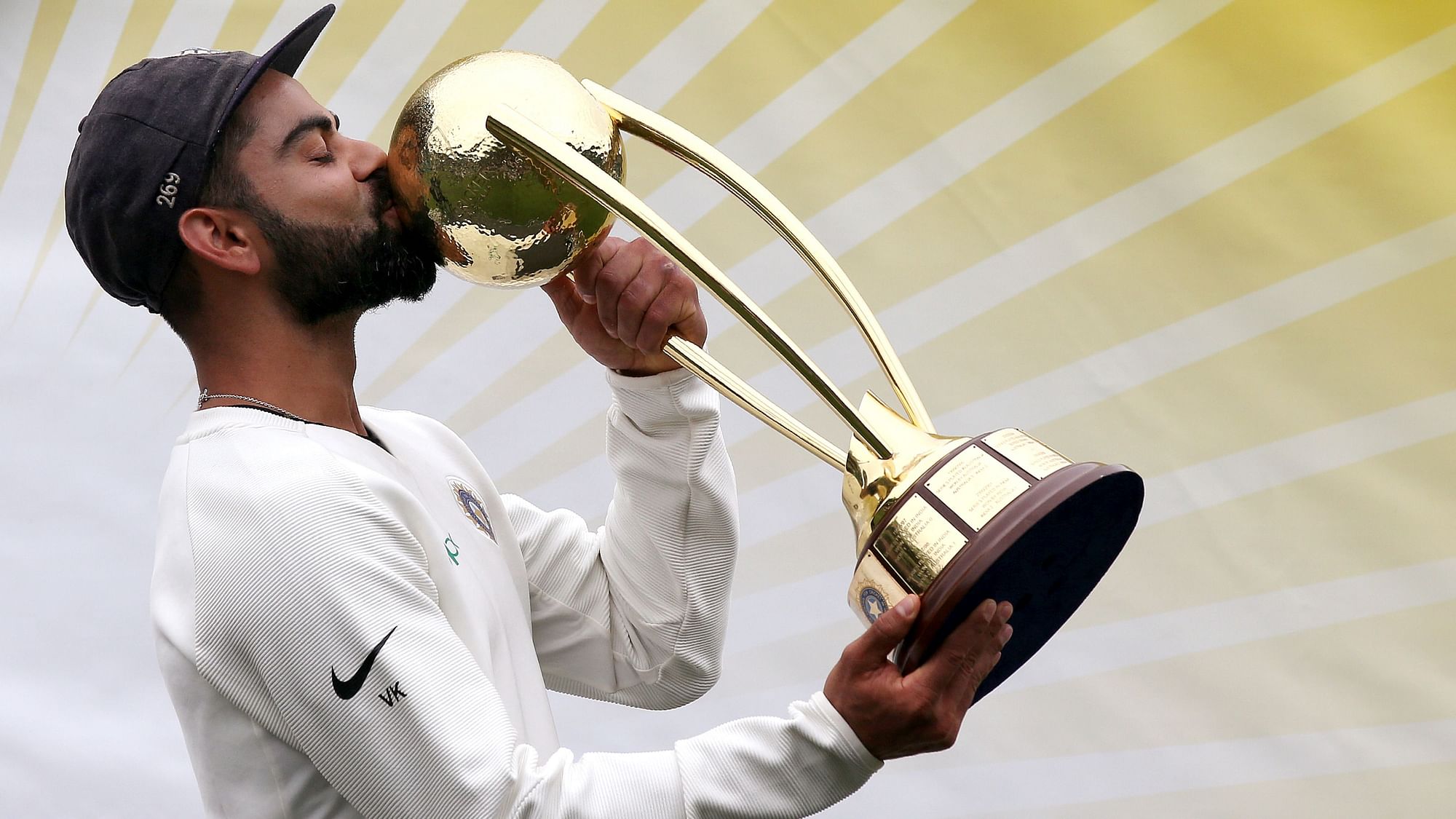 Virat Kohli kisses the Border-Gavaskar Trophy after leading India to their maiden Test series win in Australia.