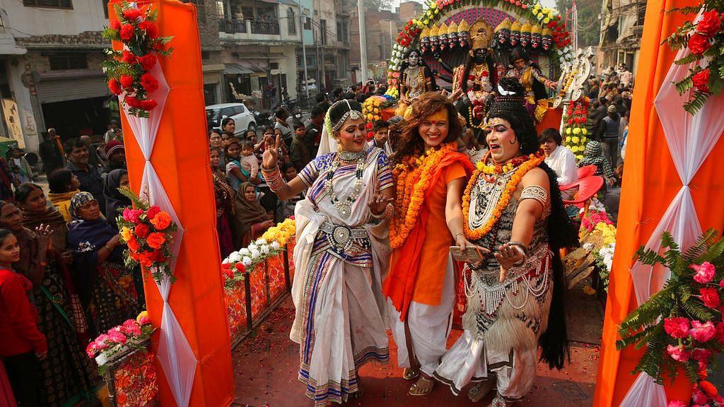 Artists perform with a member of Kinnar Akhara for transgenders, during a religious procession towards Sangam, the confluence of rivers Ganges, Yamuna and mythical Saraswati, as part of the Kumbh festival in Allahabad, on Sunday, 6 January, 2019.