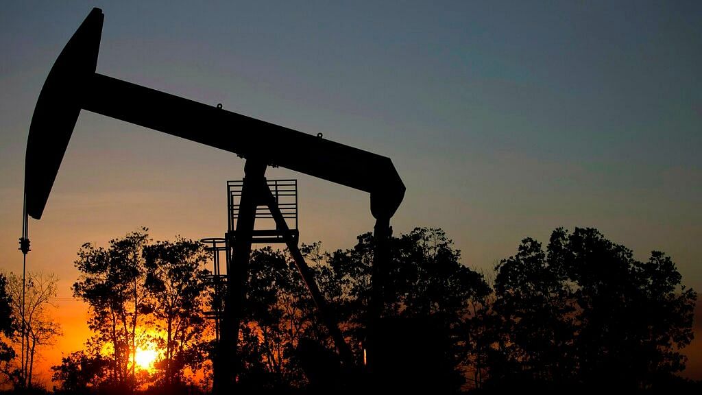  The sun sets behind an oil well in a field near El Tigre, a town within Venezuela’s Hugo Chavez oil belt, formally known as the Orinoco Belt.
