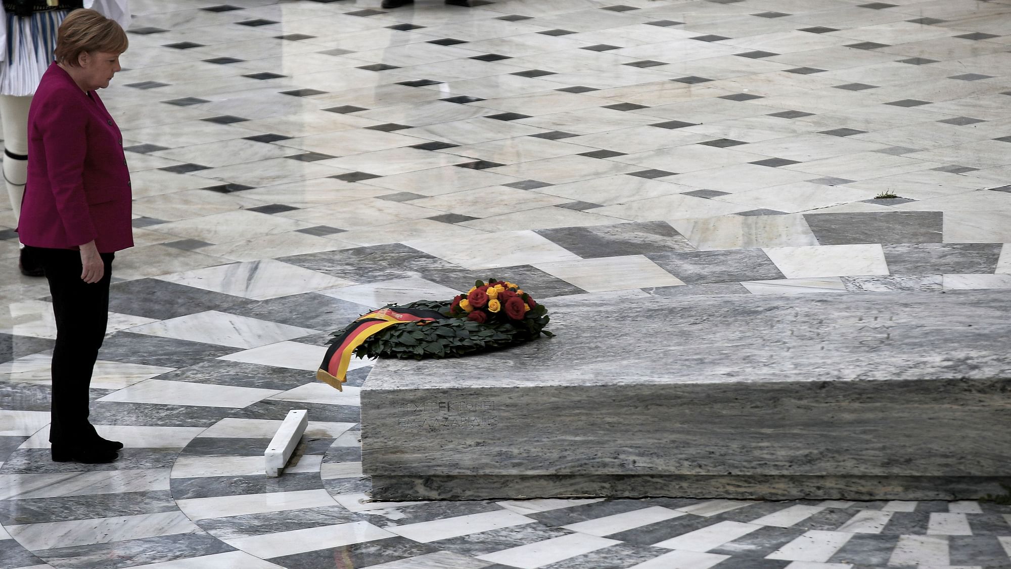 German Chancellor Angela Merkel places a wreath at the monument of the Unknown Soldier during her visit in Athens.
