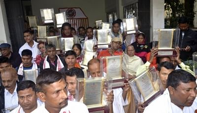 Guwahati: Family members of Assam Movement martyrs return the state honours bestowed upon their kin in 2016 as a cognition of their sacrifices, to protest against the Citizenship (Amendment) Bill, in Guwahati on Jan 30, 2019. (Photo: IANS)