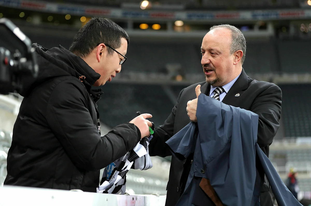 Newcastle United manager Rafael Benitez, right, signs an autograph as he arrives for the English Premier League soccer match against Newcastle, at St James’ Park in Newcastle, Tuesday Jan. 29, 2019. 