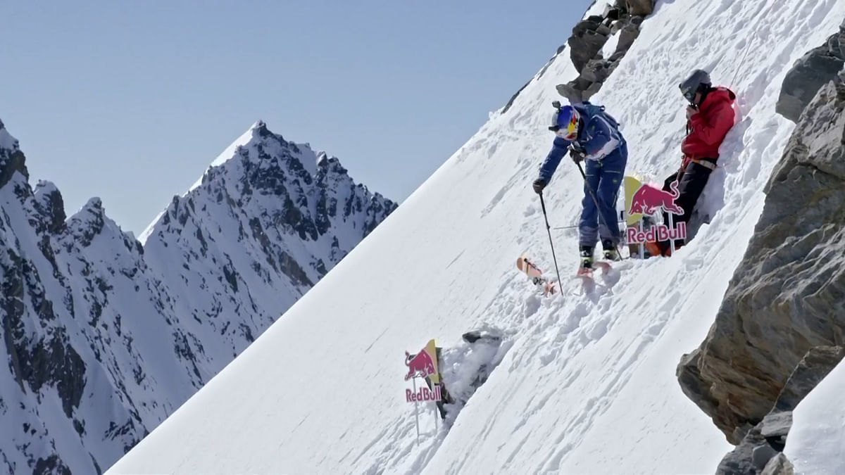 Watch the two skiers race through the picturesque mountain slope.