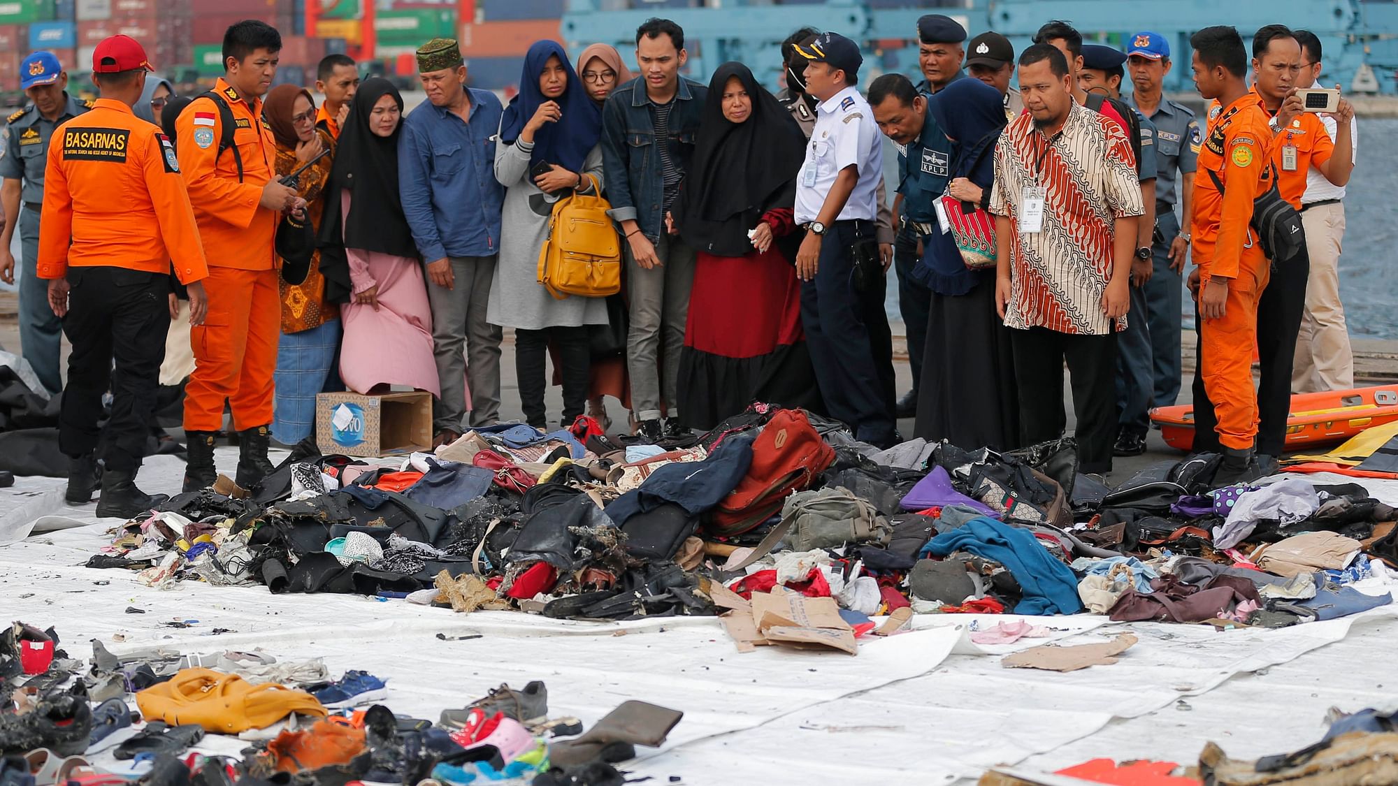 File photo of relatives of passengers of the crashed Lion Air jet check personal belongings retrieved from the waters where the airplane is believed to have crashed.