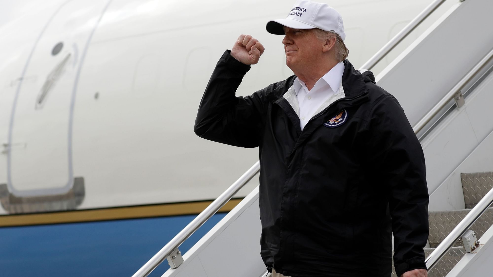 President Donald Trump gestures after arriving at McAllen International Airport for a visit to the southern border.