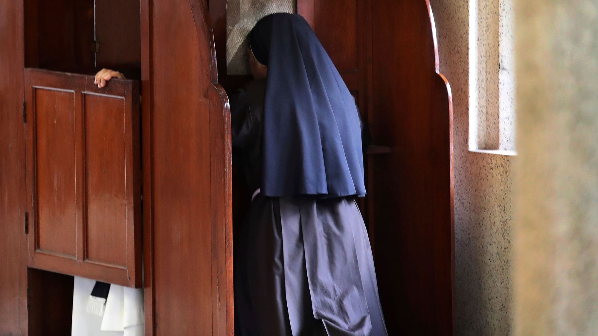 In this Sunday, 4 November , 2018, photo, a nun partakes in the sacrament of confession at the Immaculate Heart of Mary Cathedral in Kottayam.