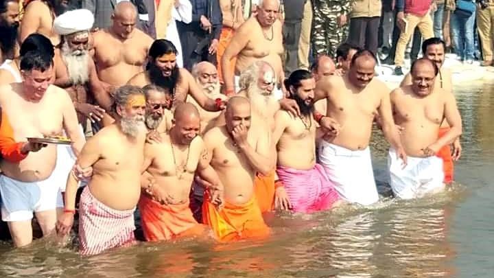 Uttar Pradesh Chief Minister Yogi Adityanath takes a holy dip in the Kumbh Mela.