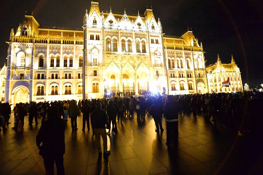 Anti-government demonstrators protest in front of the Parliament building at Kossuth square, donwtown Budapest, Hungary, Saturday, 5 January. A crowd of at least 10,000 people gathered on Saturday outside the Hungarian parliament building in Budapest to protest a law approved in December that allows employers to request up to 400 hours of overtime a year from workers.