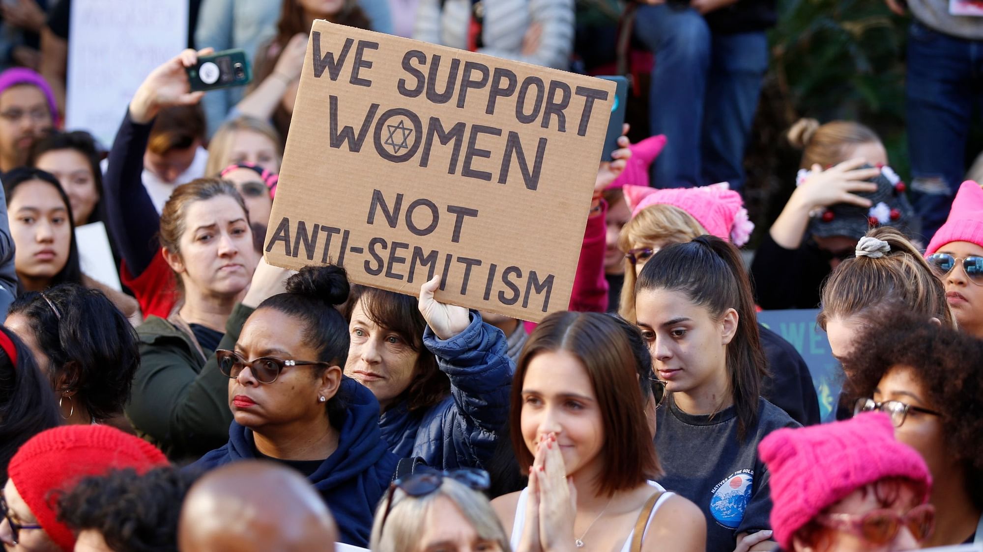 A demonstrators holds a sign against “Anti-Semitism” as she joins the Women’s March in Los Angeles on Saturday.