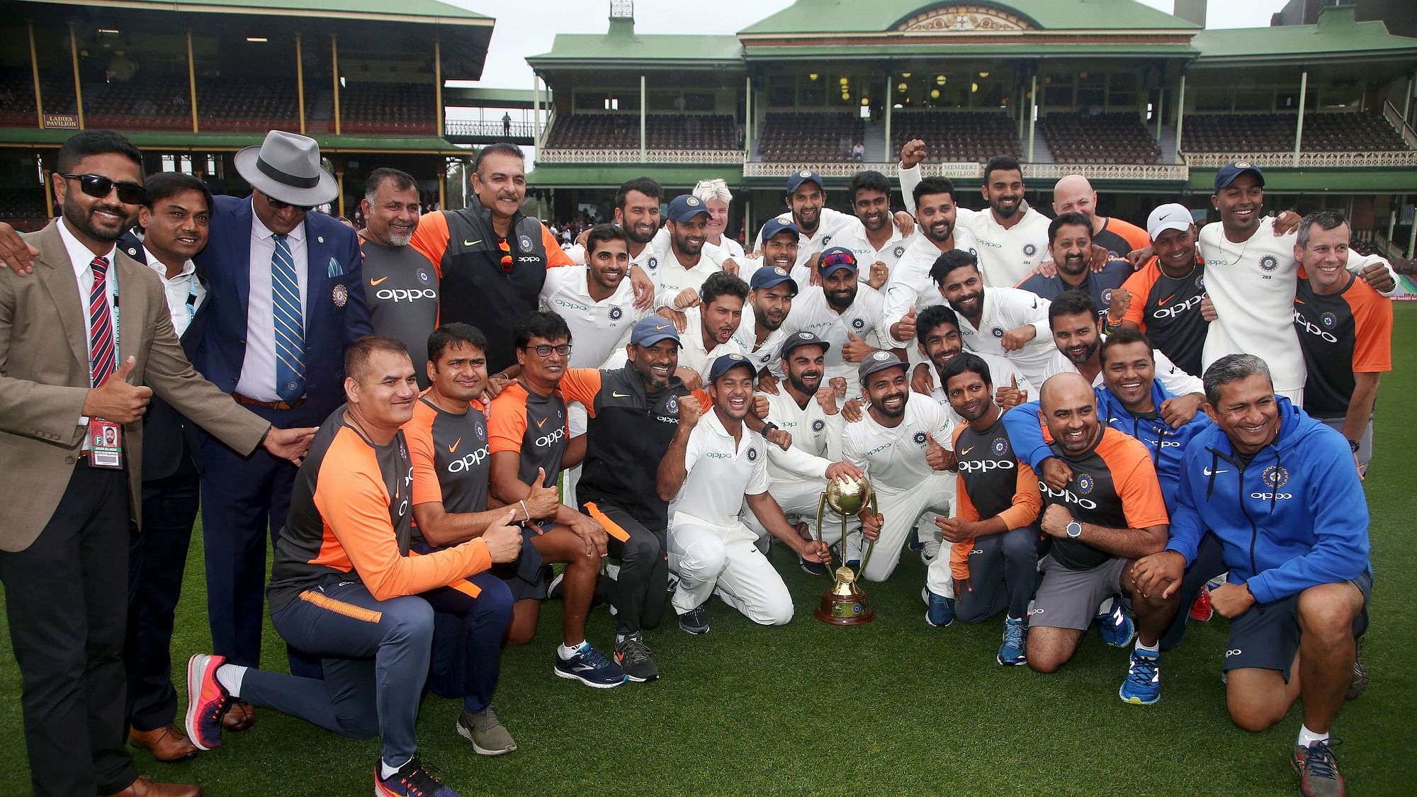 The Indian squad and support staff pose with the Border-Gavaskar Trophy after securing India’s maiden Test series win in Australia.