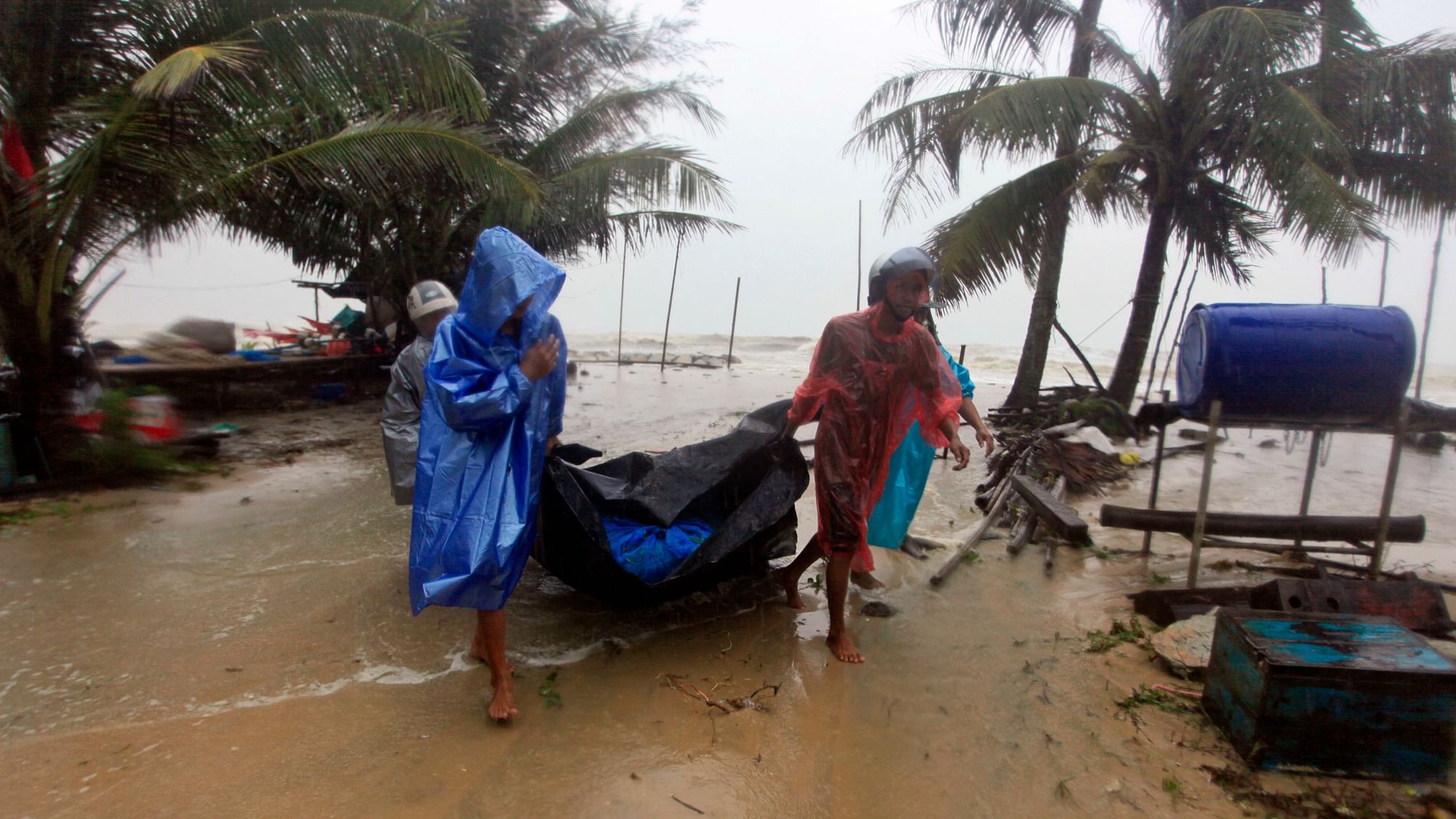 Locals clear the shoreline in preparation for the approaching Tropical Storm Pabuk, on 4 January in Pak Phanang, in the southern province of Nakhon Si Thammarat, southern Thailand. 
