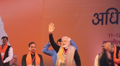 New Delhi: Prime Minister and BJP leader Narendra Modi accompanied by party president Amit Shah and party leader Dinesh Sharma, waves at party workers during the party