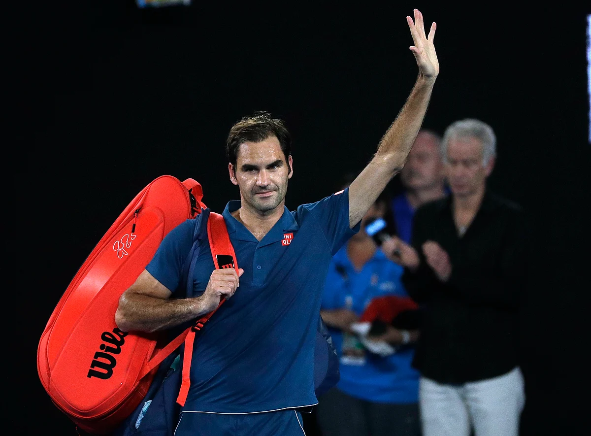 Switzerland’s Roger Federer waves as he leaves Rod Laver Arena after losing his fourth round match against Greece’s Stefanos Tsitsipas at the Australian Open. 