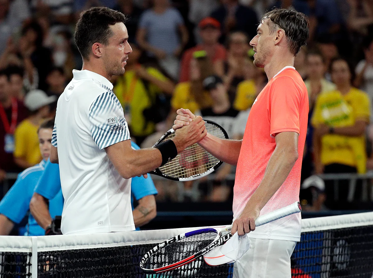 Spain’s Roberto Bautista Agut, left, is congratulated by Australia’s John Millman after winning their second round match at the Australian Open tennis championships in Melbourne, Australia, Wednesday, Jan. 16, 2019.
