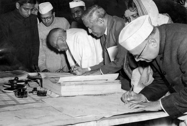 Members of the Constituent Assembly signing the Constitution