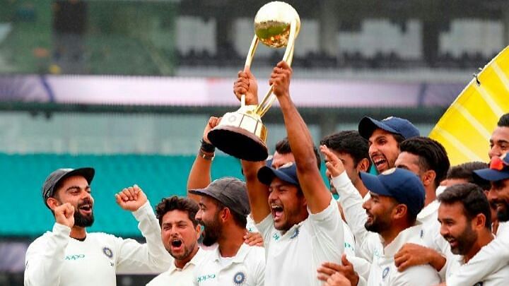 The Indian team holds aloft the Border-Gavaskar Trophy after securing India’s maiden Test series win in Australia.