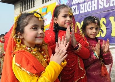 Amritsar: Children dressed up in traditional attires participate in Lohri celebrations at their school on the eve of the festival in Amritsar, on Jan 12, 2019. (Photo: IANS)