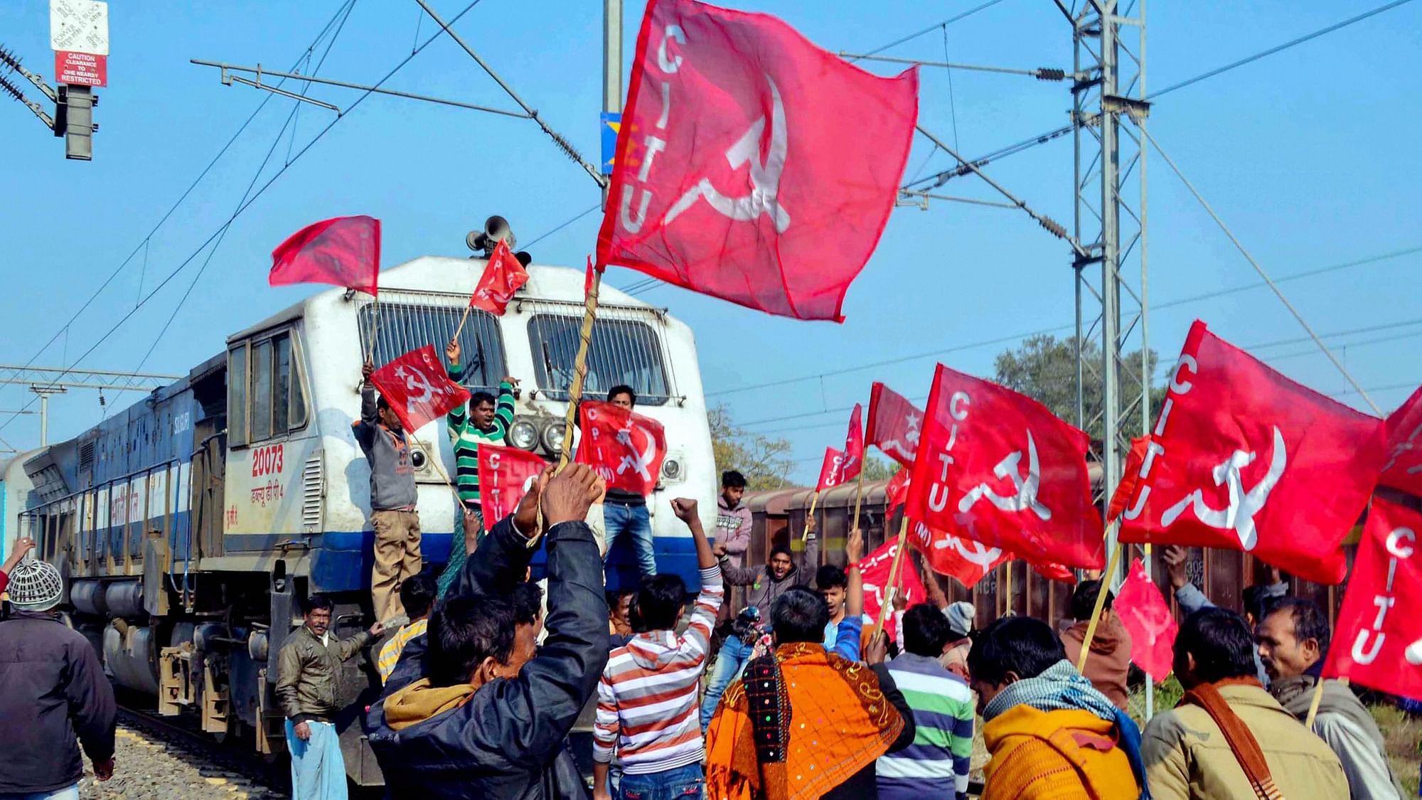 Activists under the banner of Centre of Indian Trade Unions (CITU) block a train during a 48-hour-long nationwide general strike called by central trade unions in protest against the “anti-people” policies of the Centre in Malda.