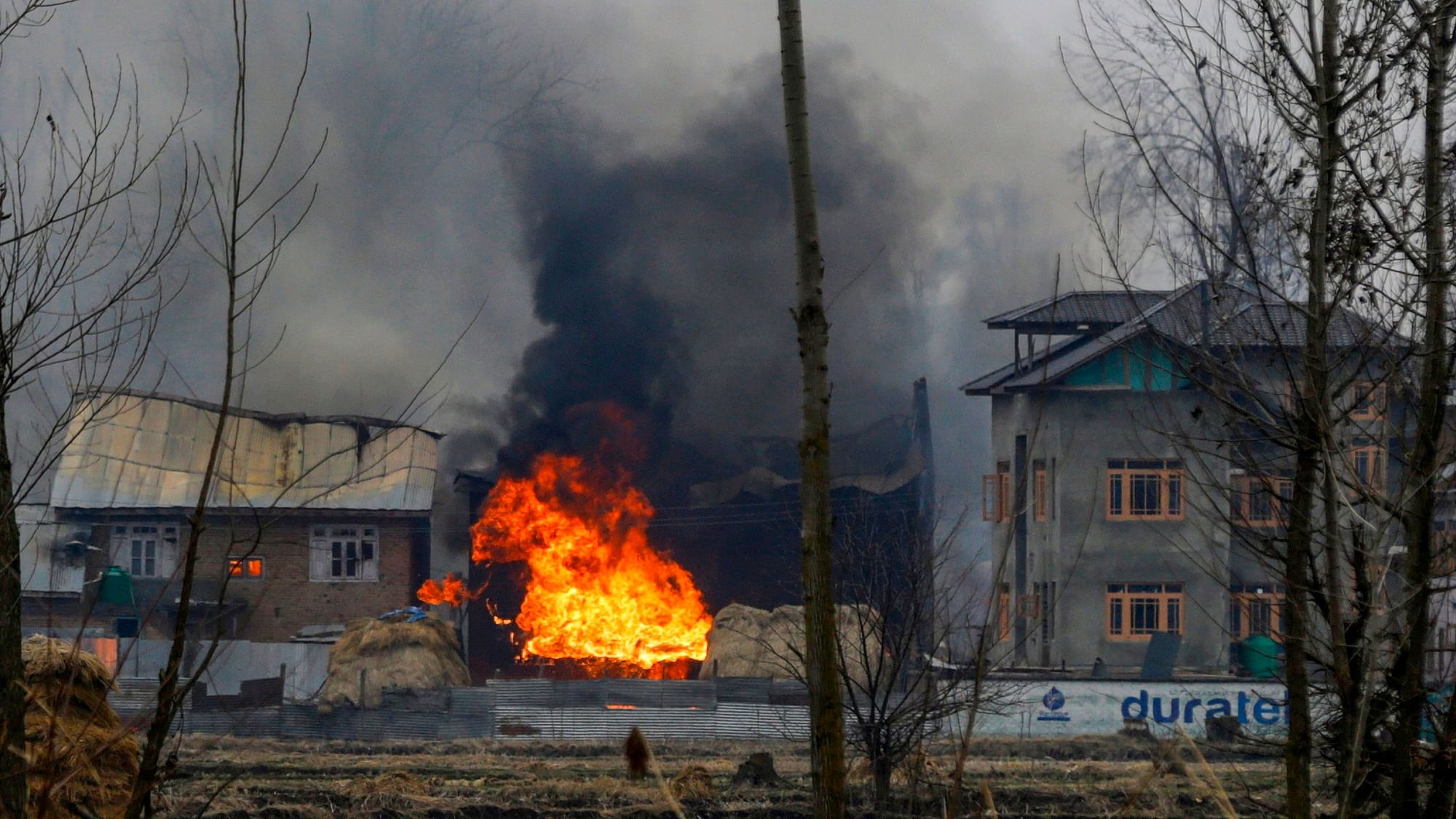 Flames rise from the house where two alleged masterminds of Lethpora suicide car bomb attacks were said to be hiding, during an encounter with the security forces, in Pinglena area.