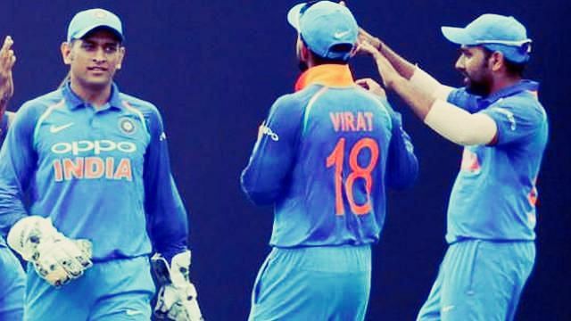 File picture of MS Dhoni, Virat Kohli and Rohit Sharma celebrating the fall of a wicket.