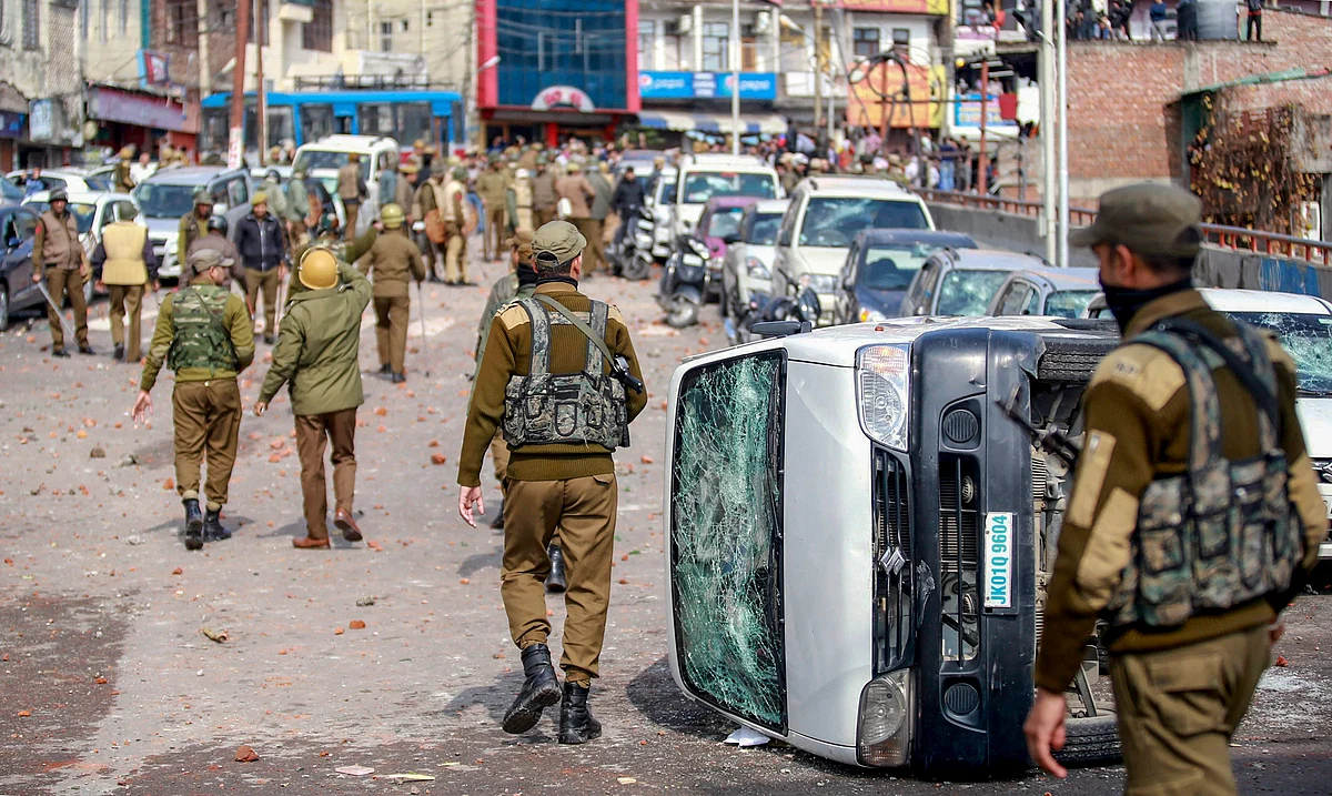 Security personnel patrol a street after vehicles set on fire by protestors against the killing of CRPF personnel in the Pulwama terror attack in Jammu.