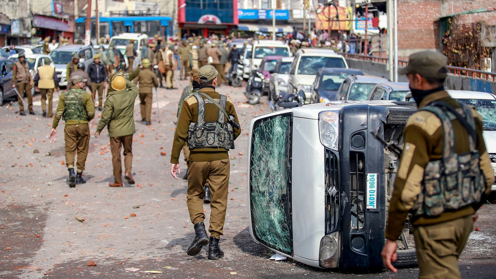  Security personnel patrol a street after vehicles set on fire by protestors against the killing of CRPF personnel in the Pulwama terror attack in Jammu.