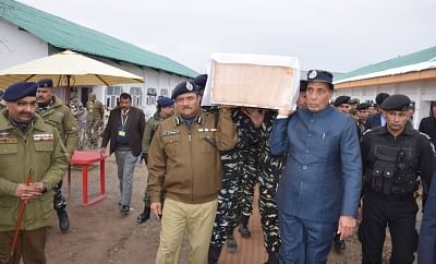 Budgam: Union Home Minister Rajnath Singh lifts the coffin of one of the one of the 45 CRPF personnel killed in a suicide attack by militants in Jammu and Kashmir