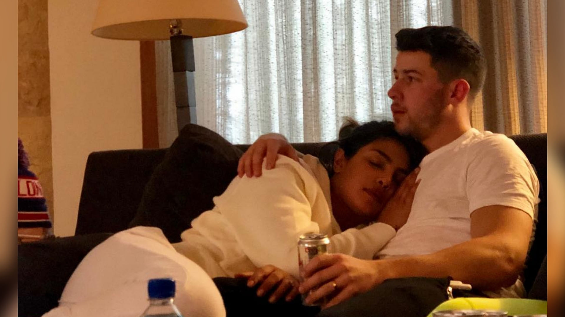Priyanka Chopra snuggles next to Nick Jonas.&nbsp;