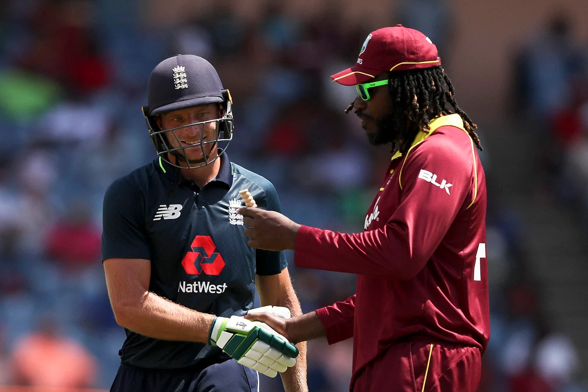 West Indies’ Chris Gayle, right, congratulates England’s Jos Buttler for his 150 runs during the fourth One Day International cricket match at the National Stadium in St. George’s, Grenada, Wednesday, Feb. 27, 2019.