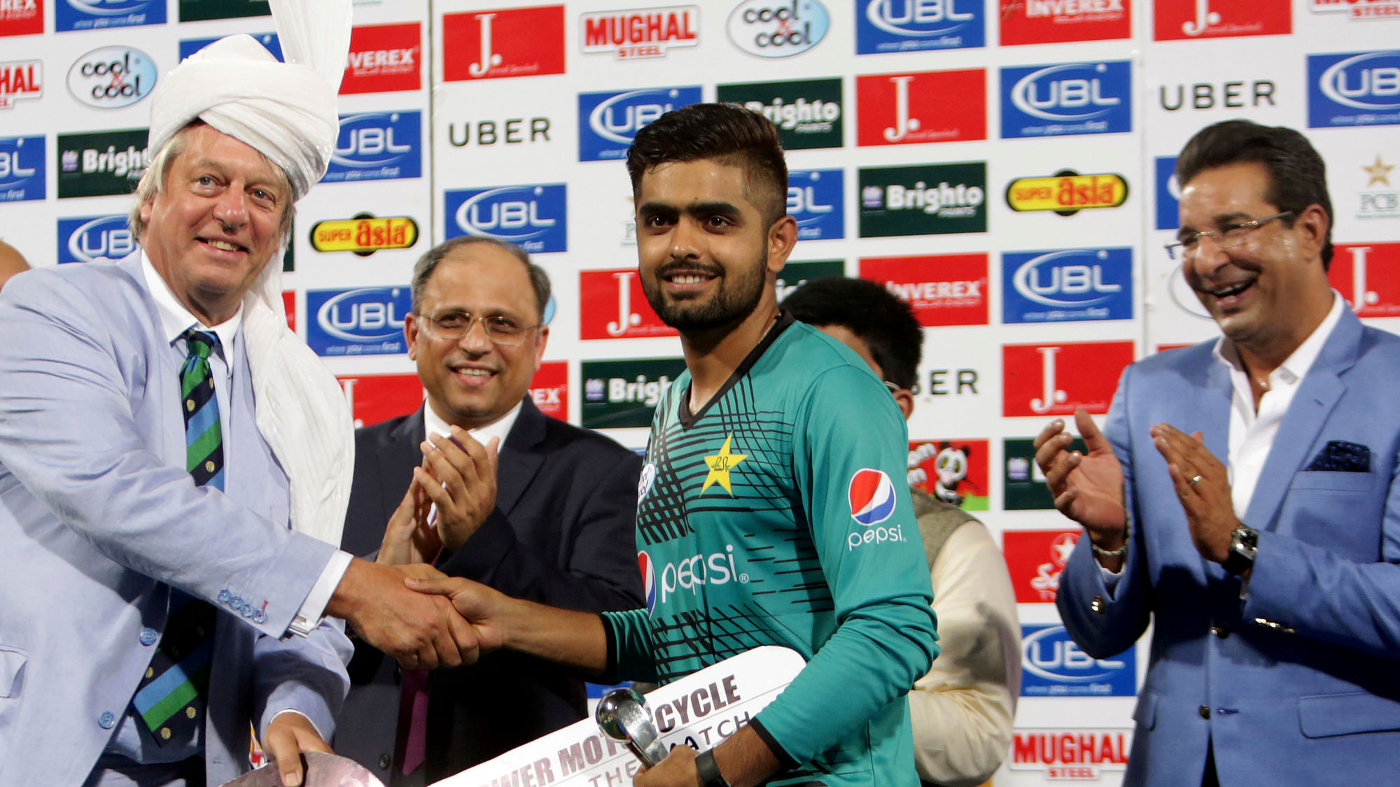 Babar Azam with a Man of the Match award during an earlier home series.