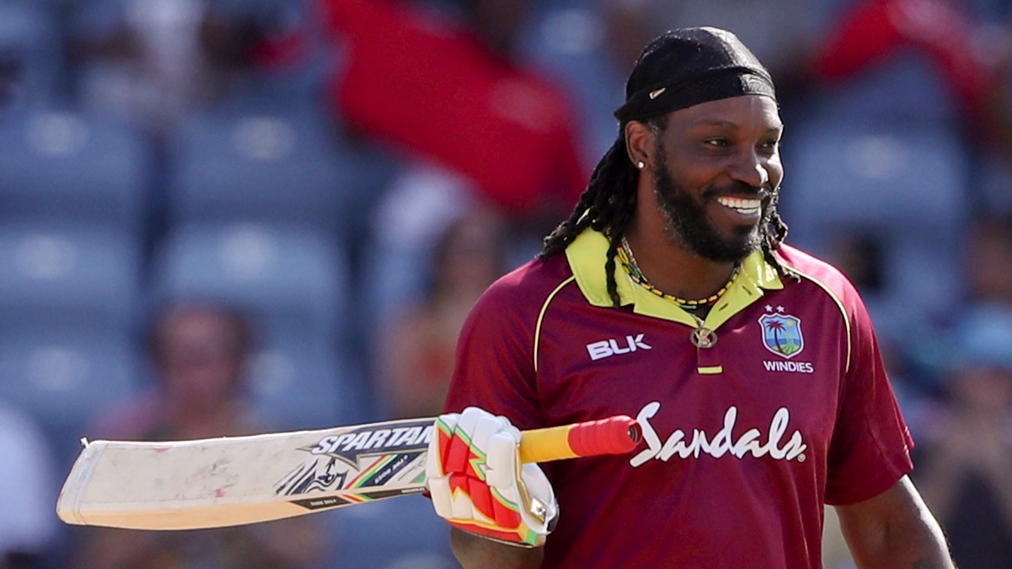 West Indies’ Chris Gayle celebrates after scoring a century against West Indies during the fourth One Day International at the National Stadium in St. George’s, Grenada, Wednesday, Feb. 27, 2019.&nbsp;