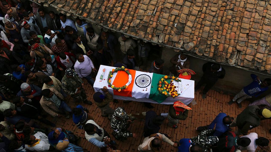 Mourners gather in Tudihar village, some 56 kilometers east of Prayagraj, Uttar Pradesh on Saturday, 16 February, 2019, for the funeral procession of Central Reserve Police Force (CRPF) soldier Mahesh Yadav who was killed in the Pulwama attack.