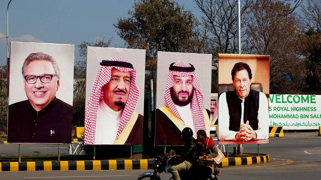 Pakistani riders drive past portraits of Pakistani and Saudi leaders display on the occasion of the visit by Saudi Arabia’s Crown Prince to Pakistan, in Islamabad.