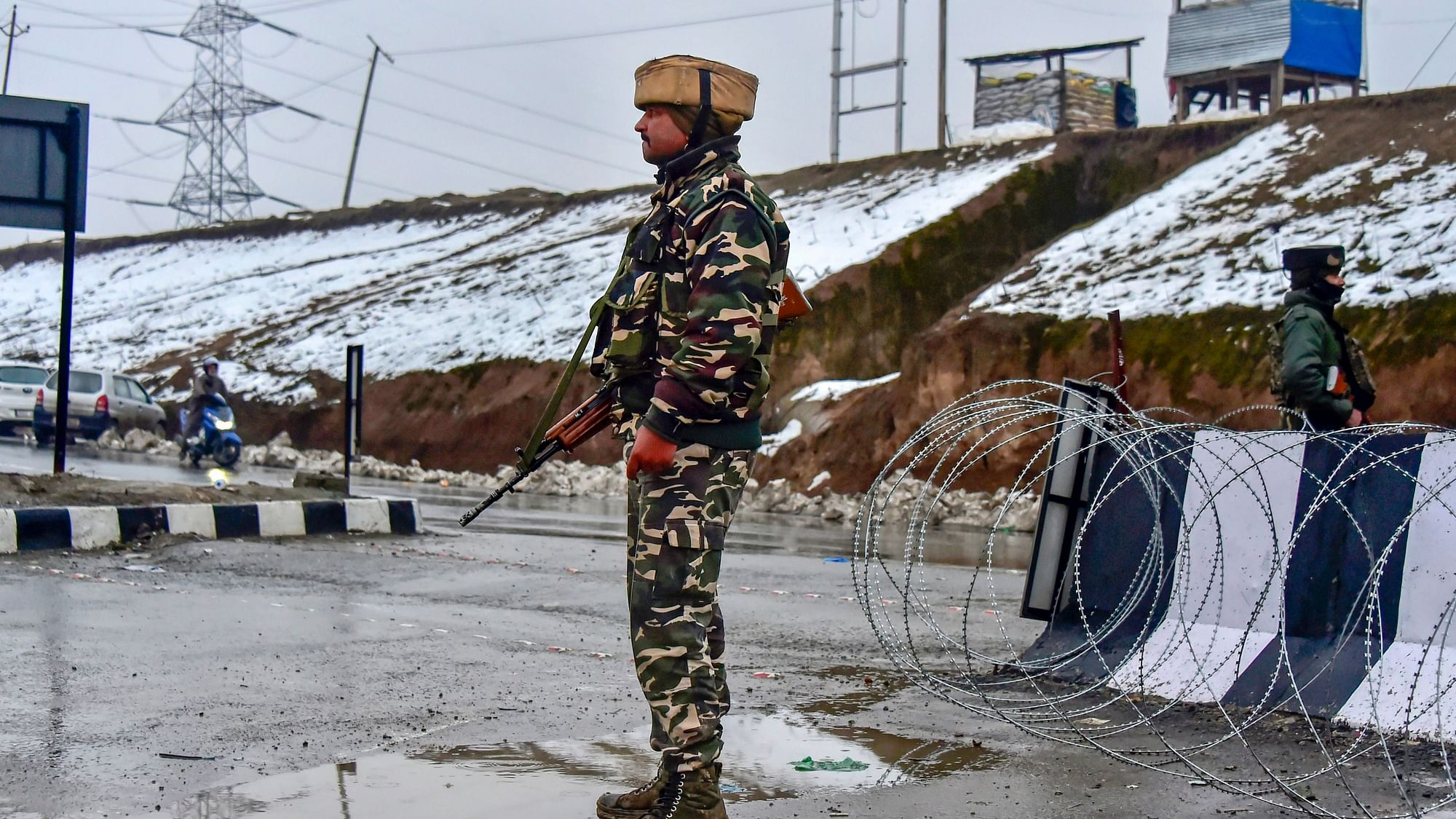 An army soldier stands guard near the site of the attack in Pulwama on 14 Feb
