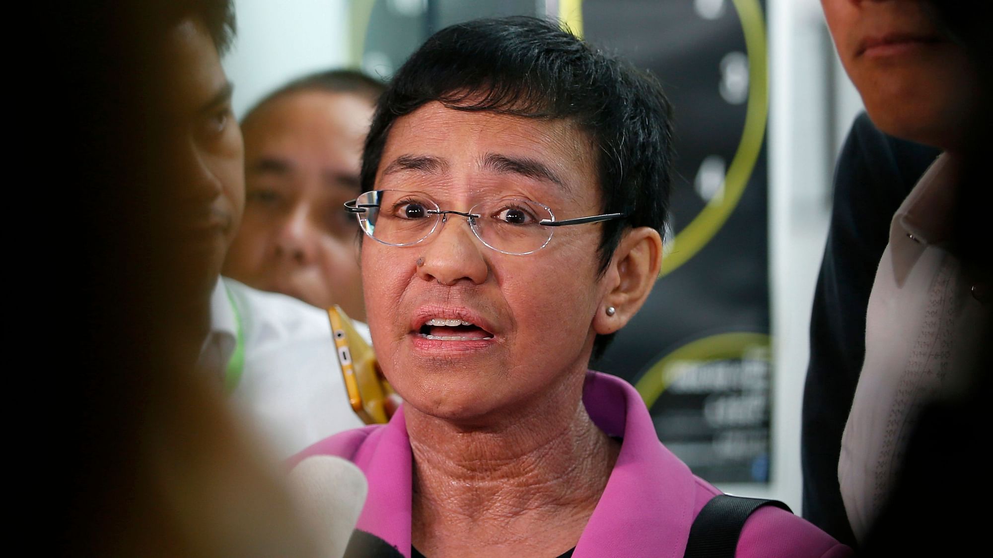Maria Ressa, CEO of the online news agency Rappler, talks to the media after attending the summons by the National Bureau of Investigation on the cyber libel complaint.
