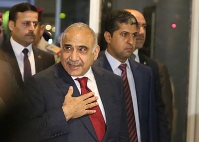 BAGHDAD, Oct. 24, 2018 (Xinhua) -- Adel Abdul Mahdi (Front) arrives at the parliament in Baghdad, Iraq, on Oct. 24, 2018. Adel Abdul Mahdi on Wednesday was sworn in as new prime minister of Iraq after the parliament passed 14 out of his 22 cabinet members. (Xinhua/IANS)