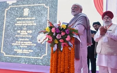 Jalpaiguri: Prime Minister Narendra Modi inaugurates the four laning of the Falakata - Salsalabari section of NH-31 D and Circuit Bench of Calcutta High Court in Jalpaiguri, West Bengal on Feb 8, 2019. Also seen Union MoS Electronics and Information Technology S.S. Ahluwalia. (Photo: IANS/PIB)