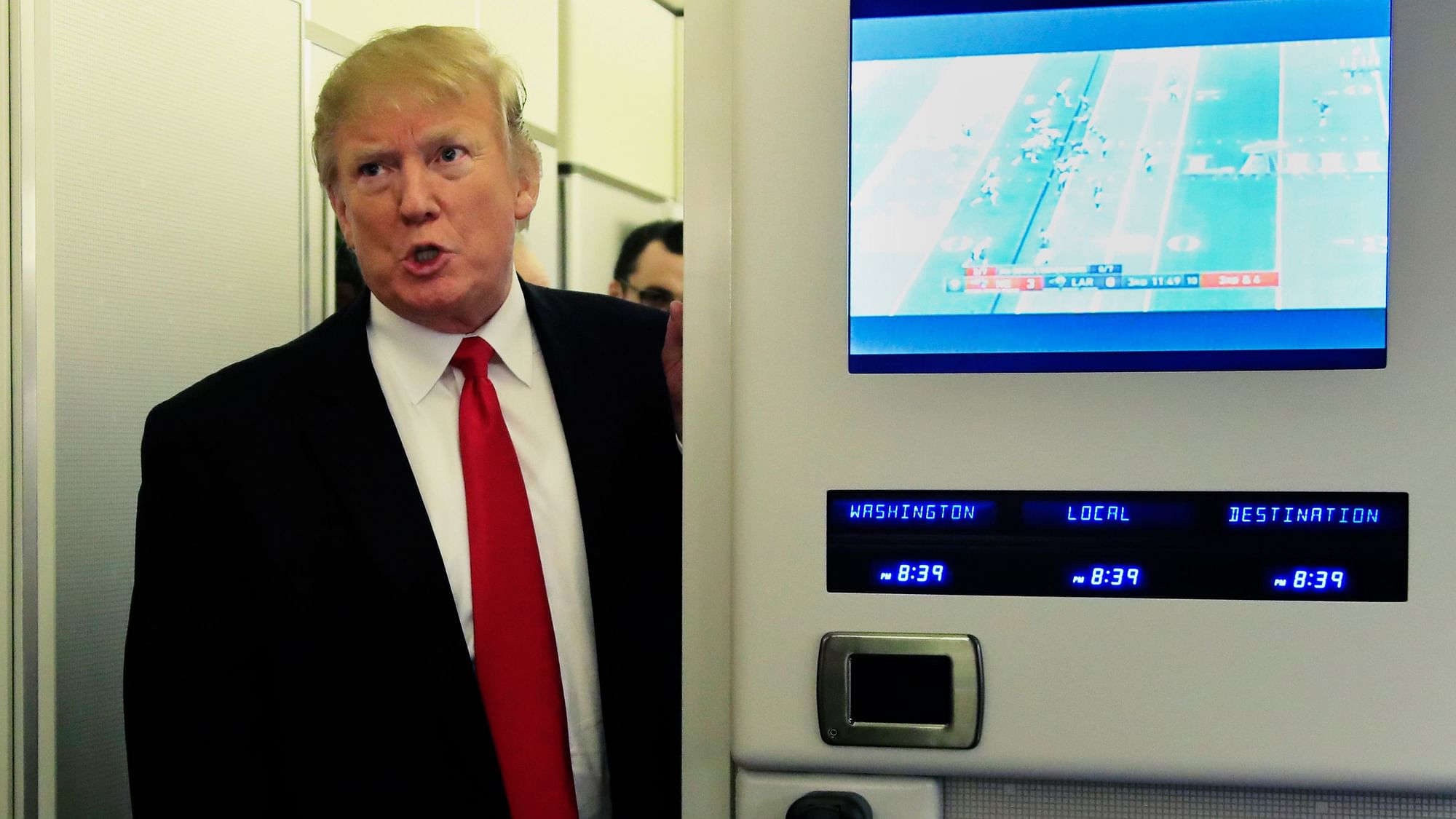 President Donald Trump speaks to reporters onboard Air Force One, on Sunday, 3 February 2019, on his way back to the White House in Washington from a weekend at his Mar-a-Lago estate in Palm Beach, Fla.
