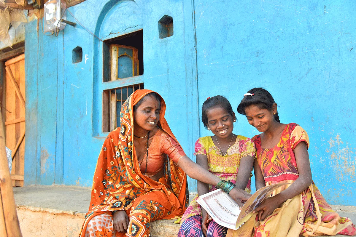 ‘During monsoons, the bridge is submerged in water’, says Bheema Nirgude. Her daughter Mathura (centre) and her friend Jyoti Hole have to walk across the bridge to reach their new school.
