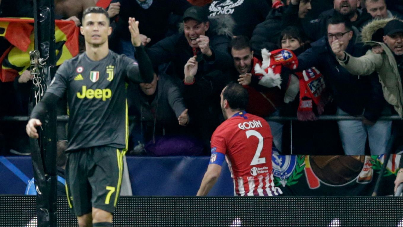 Diego Godin celebrates in the background as Cristiano Ronaldo cuts a dejected figure during Juventus’ 2-0 defeat at Atletico Madrid in the UEFA Champions League.